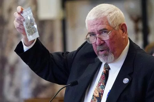 State Sen. Kevin Blackwell, R-Southaven, lead negotiator, holds a bag of hemp to illustrate to lawmakers what specific portions of the Mississippi Medical Cannabis Equivalency Units would look like during his presentation of the Mississippi Medical Cannabis Act in the Senate Chamber at the Mississippi State Capitol in Jackson, Miss., Thursday, Jan. 13, 2022. The body passed the act. (AP Photo/Rogelio V. Solis)