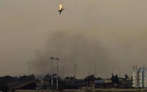 A war plane is shot down over the outskirts of Benghazi, eastern Libya, Saturday, March 19, 2011. On Friday, Feb. 25, 2022, The Associated Press reported that footage of the plane crashing in Libya in 2011 circulated online with false claims that it was captured during Russia's 2022 invasion of Ukraine. (AP Photo/Anja Niedringhaus)