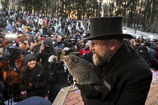 Groundhog Club handler A.J. Dereume holds Punxsutawney Phil, the weather prognosticating groundhog, during the 137th celebration of Groundhog Day on Gobbler's Knob in Punxsutawney, Pa., Feb. 2, 2023. The arrival of annual Groundhog Day celebrations Friday, Feb. 2, 2024, will draw thousands of people to see celebrity woodchuck Phil at Gobbler's Knob in Punxsutawney, Pa. — an event that exploded in popularity after the 1993 Bill Murray movie. (AP Photo/Barry Reeger, File)