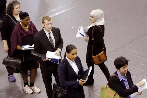 Job hunters line up for interviews at an employment fair sponsored by the New York State Department of Labor, Wednesday, Oct. 8, 2014 in the Brooklyn borough of New York. Just four months ago, city lawmakers overwhelmingly voted to require many ads for jobs in the nation's most populous city to include salary ranges, in the name of giving job applicants — particularly women and people of color — a better shot at fair pay. But on the cusp of implementing the measure, lawmakers voted Thursday 