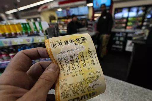 A Powerball lottery ticket is seen inside a convenience store, Monday, April 1, 2024, in Kennesaw, Ga. Powerball will match a record for lottery losing Saturday night, April 6, with a stretch of more than three months without a jackpot winner. (AP Photo/Mike Stewart, FIle)