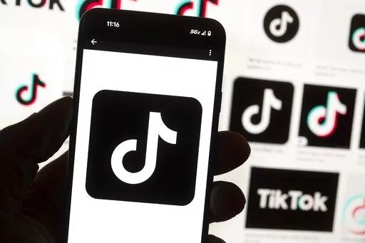 The TikTok logo is seen on a cell phone on Oct. 14, 2022, in Boston. TikTok will be banned from all Mississippi-issued government devices and the state’s network, Gov. Tate Reeves announced Wednesday, Jan. 11, 2023, in a letter to department and agency heads. Reeves says he issued the directive to safeguard sensitive information from the popular social media app. (AP Photo/Michael Dwyer, File)