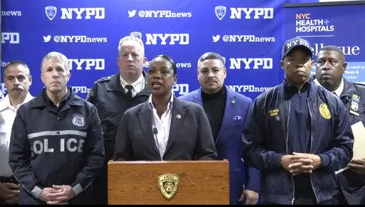 This photo provided by NYPD, New York City Police Commissioner Keechant Sewell address the media during a news conference on Saturday, Dec. 31, 2022. A man wielding a machete attacked three police officers at the New Year’s Eve celebration in New York City, authorities said, striking two of them in the head before an officer shot the man in the shoulder. The two officers were hospitalized, one with a fractured skull and the other with a bad cut, but expected to recover. (NYPD via AP)