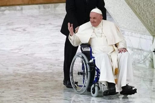 Pope Francis arrives in a wheelchair to attend an audience with nuns and religious superiors in the Paul VI Hall at The Vatican, Thursday, May 5, 2022. Pope Francis, whose mobility has been limited of late by a nagging knee problem, is looking forward to visiting South Sudan in July, according to a joint message by the pontiff, the archbishop of Canterbury and a Scottish church official. (AP Photo/Alessandra Tarantino, File)
