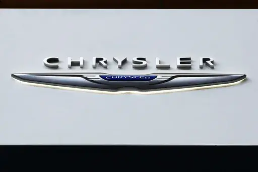 The Chrysler logo is on display at the Pittsburgh International Auto Show, Feb. 11, 2016, in Pittsburgh. On Saturday, June 8, 2024, the National Highway Traffic Safety Administration announced that Chrysler is recalling more than 211,000 SUVs and pickup trucks in the U.S., due to a software malfunction that could disable the cars' electronic stability control systems. (AP Photo/Gene J. Puskar, File)