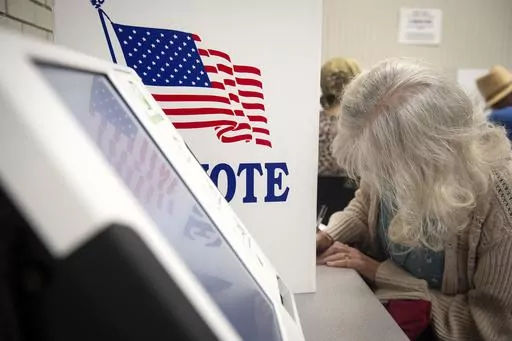 Voters fill in their ballots at at Precinct 5 at Wood Activity & Therapeutic Center in Clinton, Miss., during the general election, Nov. 7, 2023. The chairman of a congressional committee that has broad oversight of U.S. federal elections says ballot shortages in Mississippi's largest county could undermine voting and election confidence in 2024 if local officials don’t make changes. (Barbara Gauntt/The Clarion-Ledger via AP, file)