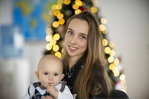 Vlada Yushchenko, a 19-year-old Ukrainian refugee, holds her son Daniel, during an interview with The Associated Press in Brasov, Romania, Thursday, Feb. 2, 2023. Yushchenko was still in her teens and nearly three months pregnant when she hugged her husband at the border, turned away and walked into Moldova. Now she’s in Romania, one of the millions of Ukrainians forced to flee Russia’s invasion of their country. Her baby, Daniel, was born there eight months ago and still hasn’t met his fa