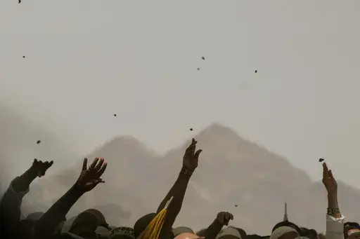 Muslim pilgrims cast stones at pillars in the symbolic stoning of the devil during the annual Hajj, in Mina near the holy city of Mecca, Saudi Arabia, on June 30, 2023. Once a year, Muslim pilgrims coming to Saudi Arabia from around the world unite in a series of religious rituals and acts of worshipping God as they perform Hajj, one of the pillars of Islam. Among other rituals, pilgrims throw pebbles in a symbolic stoning of the devil. (AP Photo/Amr Nabil, File)