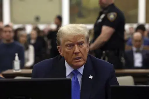 Former President Donald Trump waits to take the witness stand during his civil fraud trial at New York Supreme Court, Monday, Nov. 6, 2023, in New York. A judge in Michigan is expected to hear arguments as to whether or not Secretary of State Jocelyn Benson has the authority to keep Trump’s name off any state ballot for president. Activists are suing Benson in the Michigan Court of Claims to force her to keep Trump’s name off ballots.(Brendan McDermid/Pool Photo via AP)