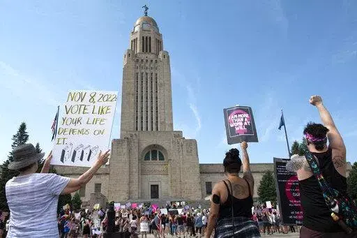 Protesters line the street around the front of the Nebraska State Capitol during an Abortion Rights Rally held on July 4, 2022, in Lincoln, Neb. A Nebraska woman has been charged in early June with helping her teenage daughter end her pregnancy at about 24 weeks after investigators uncovered Facebook messages in which the two discussed using medication to induce an abortion and plans to burn the fetus afterward. (Kenneth Ferriera/Lincoln Journal Star via AP, File)