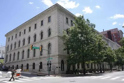 A pedestrian passes by the US 4th Circuit Court of Appeals Courthouse on Main Street in Richmond, Va., Wednesday, June 16, 2021. In a ruling Tuesday, April, April 16, 2024, a federal appeals court has overturned a West Virginia transgender sports ban, finding that the law violates Title IX, the federal civil rights law that prohibits sex-based discrimination in schools. (AP Photo/Steve Helber, File)