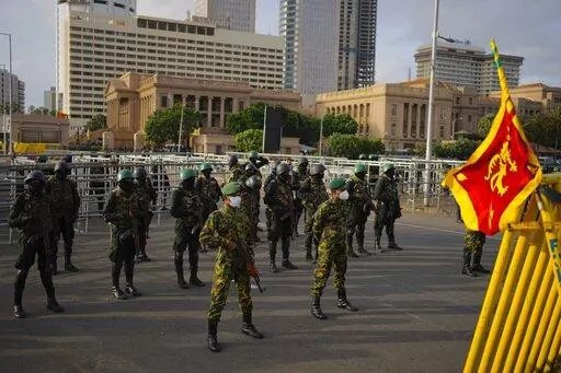 Police commandoes and army soldiers stand guard outside the president's office, after troops and police cleared the main camp of protestors following months of demonstrations, in Colombo, Sri Lanka, Saturday, July 23, 2022. (AP Photo/Eranga Jayawardena)