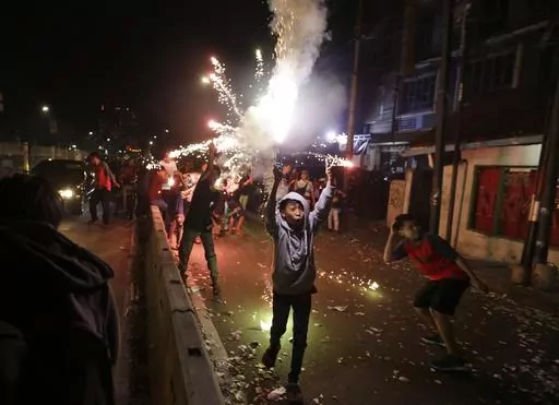 Youths light firecrackers and flares as they celebrate the end of the fasting month of Ramadan on a street in Jakarta, Indonesia, Tuesday, June 4, 2019. Islam follows a lunar calendar and so Ramadan and Eid cycle through the seasons. In 2024, the first day of Eid al-Fitr is expected to be on or around April 10; the exact date may vary among countries and Muslim communities. (AP Photo/Dita Alangkara, File)