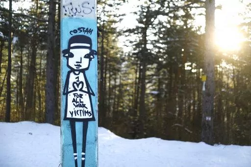 Graffiti is seen on a bob and luge track on mount Trebevic near the capital Sarajevo, Bosnia, Thursday, March 3, 2022. Survivors of the 1992-95 siege of Sarajevo cannot look away from what they say is a very similar tragedy now unfolding in Ukraine. Bosnian Serbs laid siege to Sarajevo in the early 1990s, leaving some 350,000 people trapped in the city, subjected to daily shelling and sniper attacks and cut off from regular access to electricity, food, water, medicine, and the outside world. (AP