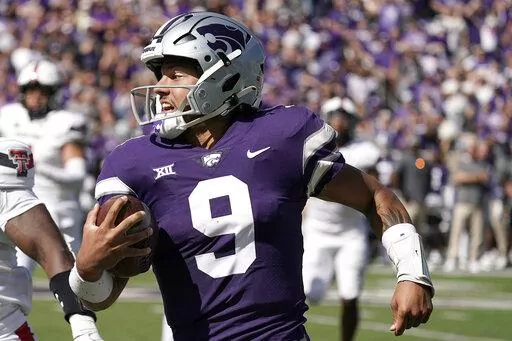 Kansas State quarterback Adrian Martinez runs the ball during the first half of an NCAA college football game against Texas Tech Saturday, Oct. 1, 2022, in Manhattan, Kan. Kansas State quarterback Adrian Martinez and Iowa linebacker Jack Campbell were among 15 players named finalists Wednesday, Oct. 26, 2022, for the William V. Campbell Trophy, given to college football's top scholar-athlete.(AP Photo/Charlie Riedel, File)