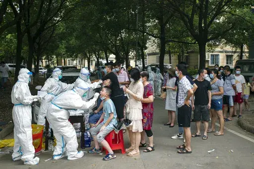 Residents line up to be tested for COVID-19 in Wuhan, central China's Hubei province on Aug. 3, 2021. Two new studies provide more evidence that the coronavirus pandemic originated in a Wuhan, China market where live animals were sold – further bolstering the theory that the virus emerged in the wild rather than escaping from a Chinese lab. The research was published online Tuesday, July 26, 2022, by the journal Science. (Chinatopix via AP, File)