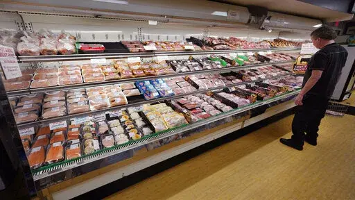 A man looks at beef in the meat department at Lambert's Rainbow Market, on  June 15, 2021 in Westwood, Mass.  The Labor Department said Thursday, Feb. 10, 2022,  that consumer prices jumped 7.5% last month compared with a year earlier, the steepest year-over-year increase since February 1982. The acceleration of prices ranged across the economy, from food and furniture to apartment rents, airline fares and electricity.  (AP Photo/Charles Krupa)