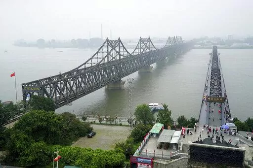 Visitors walk across the Yalu River Broken Bridge, right, next to the Friendship Bridge connecting China and North Korea in Dandong in northeastern China's Liaoning province, Sept. 9, 2017. After spending two years in a strict lockdown because of the COVID-19 pandemic, North Korea may finally be opening up — slowly. The reason could reflect a growing sense of recognition by the leadership that the nation badly needs to win outside economic relief. (AP Photo/Emily Wang, File)