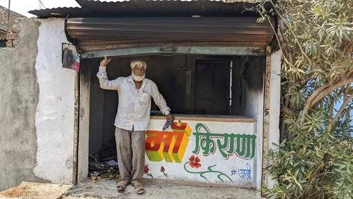 Nawab Khan stands by the entrance of his shop  vandalized by a mob on April 10 in Khargone, in the central Indian state of Madhya Pradesh, Tuesday, April 12, 2022. On April 10, a Hindu festival marking the birth anniversary of Lord Ram turned violent in Khargone after Hindu mobs brandishing swords and sticks marched past Muslim neighborhoods and mosques. Videos showed hundreds of them dancing and cheering in unison to songs blared from loudspeakers that included calls for violence against Muslim