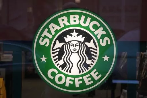 The Starbucks sign is displayed in the window of a Pittsburgh Starbucks, Jan. 30, 2023. On Monday, June 12, jurors in a federal court in New Jersey awarded $25.6 million to a former regional Starbucks manager who alleged that she and other white employees were unfairly punished by the coffee chain after the high-profile 2018 arrests of two Black men at one of the chain's Philadelphia locations. (AP Photo/Gene J. Puskar, File)