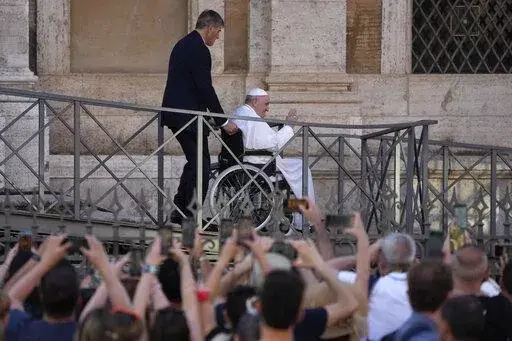 FILE-- Pope Francis greets the faithful as he leaves St. Mary Major Basilica after participating in a rosary prayer for peace, in Rome, Tuesday, May 31, 2022. Pope Francis canceled a planned July trip to Africa on doctors' orders because of ongoing knee problems, the Vatican said Friday, June 10, 2022, raising further questions about the health and mobility problems of the 85-year-old pontiff.  (AP Photo/Gregorio Borgia)