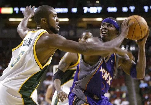 Seattle SuperSonics' Galen Young (5) guards Phoenix Suns' Quentin Richardson during the first half of a preseason basketball game Saturday, Oct. 16, 2004, in Seattle. A woman who crashed her car into a Memphis house has been charged with vehicular homicide in the death of Galen Young, a former college and pro basketball player found dead in the home, prosecutors said Tuesday, April 19, 2022.(AP Photo/Jim Bryant, File)