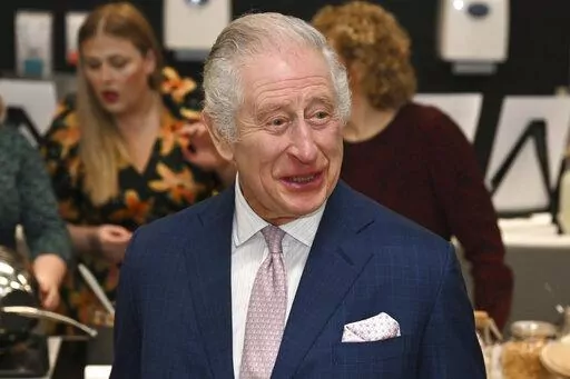 Britain's King Charles III visits the kitchen inside the headquarters of cereal manufacturer Kellogg's marking its 100th anniversary in Manchester, England, Friday Jan. 20, 2023. (Paul Ellis/Pool via AP)