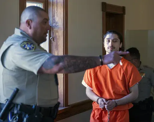 Ryan Martinez is led into court for a preliminary and detention hearing at the Rio Arriba Courthouse, in Tierra Amarilla, N.M., Friday, Oct. 13, 2023. (Eddie Moore/The Albuquerque Journal via AP, File)