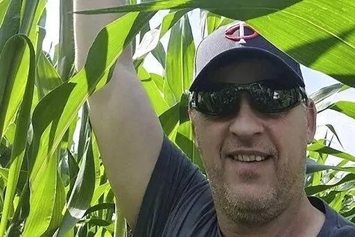 In this image courtesy of Kristi Magnusson, Kurt Groszhans in one of his fields in Ukraine in July 2021. The American farmer is jailed in Ukraine on charges he attempted to assassinate a former business partner who is now a government minister. The family of Groszhans says the charges are bogus and designed to stifle his claims of corruption. His former partner, Roman Leshchenko, has denied that he embezzled money from the American's company. (Kristi Magnusson via AP)