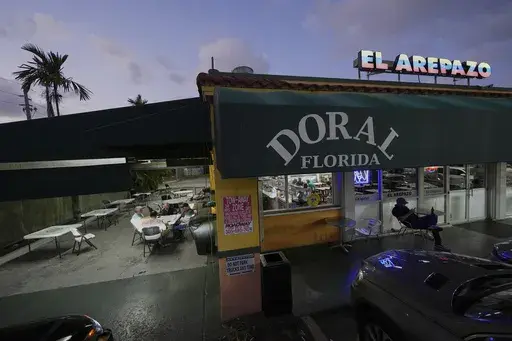 U.S. citizens who immigrated from Venezuela between 16 and 30 years ago play dominos outside El Arepazo, a restaurant that is a hub of the largest Venezuelan community in the U.S., in Doral, Fla., Wednesday, April 2, 2025. Many of the friends, including Cesar Mena, at right, voted for President Donald Trump and continue to support him. "I have family and friends on TPS [Temporary Protected Status] and I feel bad for them. But it's a temporary situation, and you need to resolve the problem." (AP 