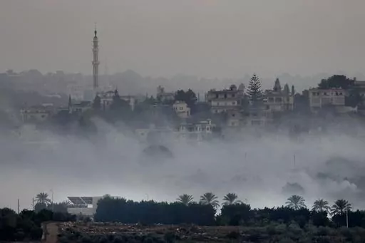 Israeli artillery shelling smoke covers Dahaira, a Lebanese border village with Israel, south Lebanon, Monday, Oct. 16, 2023. Lebanon's militant Hezbollah group says its fighters have targeted an Israeli position along the border directly hitting a Merkava tank. (AP Photo/Hussein Malla)