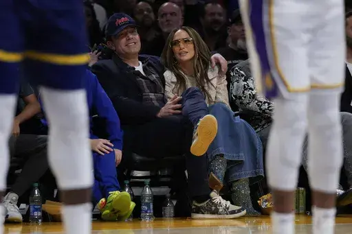 Ben Affleck and Jennifer Lopez watch an NBA basketball game between the Golden State Warriors and the Los Angeles Lakers in Los Angeles, March 16, 2024. (AP Photo/Ashley Landis, File)