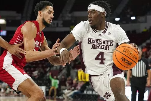 Mississippi State guard Cameron Matthews (4) drives up court against Nicholls State forward Marek Nelson (0) during the first half of an NCAA college basketball game, in Starkville, Miss., Saturday, Dec. 17, 2022. (AP Photo/Rogelio V. Solis)