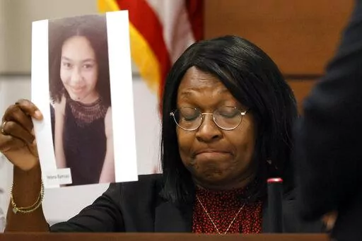 Anne Ramsay holds a picture of her daughter, Helena, before giving her victim impact statement during the penalty phase of the trial of Marjory Stoneman Douglas High School shooter Nikolas Cruz at the Broward County Courthouse in Fort Lauderdale on Thursday, Aug. 4, 2022. Helena was killed in the 2018 shootings. Cruz previously plead guilty to all 17 counts of premeditated murder and 17 counts of attempted murder in the 2018 shootings. (Amy Beth Bennett/South Florida Sun Sentinel via AP, Pool)