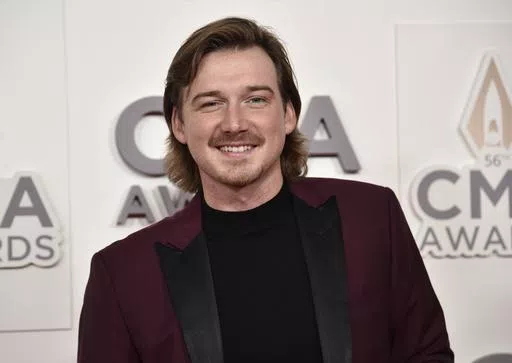 Morgan Wallen arrives at the 56th annual CMA Awards, Nov. 9, 2022, in Nashville, Tenn. On Tuesday, May 21, 2024, Nashville councilmembers rejected plans for a glowing sign at Wallen's new bar along the city's neon-lit strip of honky tonks, citing his use of a racial slur publicized in 2021 and his recent criminal charges of throwing a chair off a rooftop and nearly hitting two police officers. (Photo by Evan Agostini/Invision/AP, File)