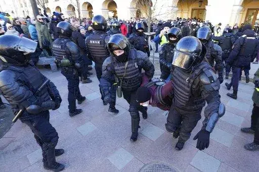 Police detain a demonstrator during an action against Russia's attack on Ukraine in St. Petersburg, Russia, Sunday, Feb. 27, 2022. Protests against the Russian invasion of Ukraine resumed on Sunday, with people taking to the streets of Moscow and St. Petersburg and other Russian towns for the third straight day despite mass arrests. (AP Photo/Dmitri Lovetsky)