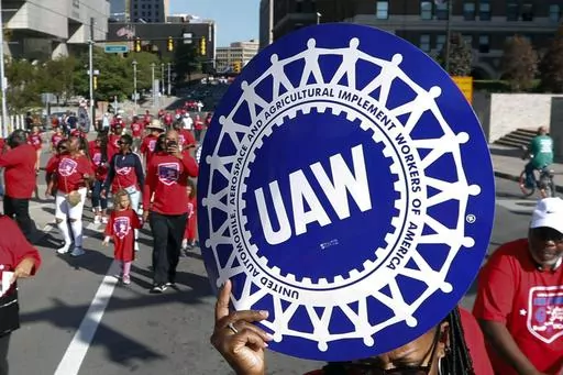 United Auto Workers members walk in the Labor Day parade, Sept. 2, 2019, in Detroit. The United Auto Workers union announced plans Wednesday, Nov. 29, 2023, to try to simultaneously organize workers at more than a dozen nonunion auto factories. (AP Photo/Paul Sancya, File)