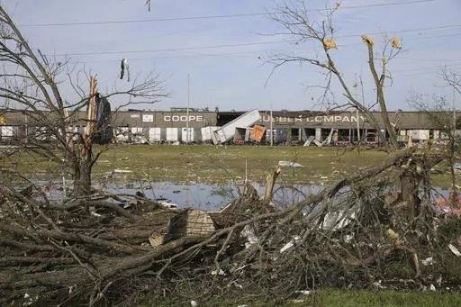The broken and damaged trees along U.S. Hwy 45 South are covered with metal and other materials that were ripped off the nearby Cooper Tire and Rubber Company, on April 1, 2023, in Tupelo, Miss. Production at the large north Mississippi tire plant has ground to a halt in the wake of a damaging tornado, halting operations at the second-largest production facility for Goodyear’s North American network. (Thomas Wells/The Northeast Mississippi Daily Journal via AP, File)