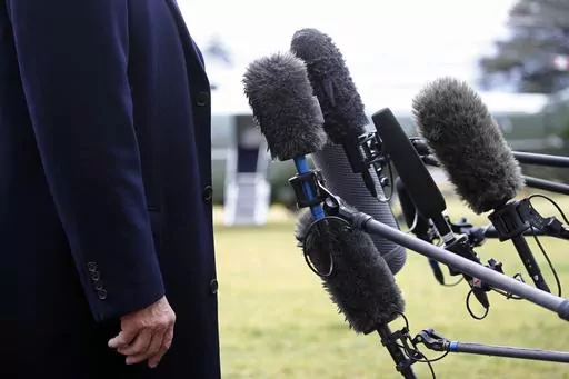 President Donald Trump stands in front of microphones as he speaks to members of the media on the South Lawn of the White House in Washington, Friday, Feb. 7, 2020, before boarding Marine One. Nearly three-quarters of U.S. adults say the news media is increasing political polarization in this country, and just under half say they have little to no trust in the media's ability to report the news fairly and accurately, according to a new survey from The Associated Press-NORC Center for Public Affa
