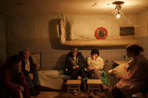 Hospital staff sit in a basement, used as a bomb shelter, during an air raid alarm in Brovary, north of Kyiv, Ukraine, Thursday, March 17, 2022. (AP Photo/Felipe Dana)