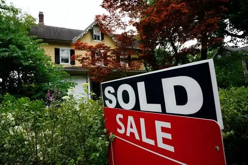 A sale sign stands outside a home in Wyndmoor, Pa., Wednesday, June 22, 2022. The National Association of Realtors has agreed on Friday, March 15, 2024, to pay $418 million and change its rules to settle lawsuits claiming homeowners have been unfairly forced to pay artificially inflated agent commissions when they sold their home. (AP Photo/Matt Rourke, File)
