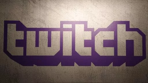 The logo of live streaming video platform Twitch is shown at the Paris games week in Paris, Saturday, Nov. 4, 2017. The shooting in Buffalo has put a spotlight on how social media companies are monitoring content that appears on their platforms. The suspected gunman shot 11 Black and two white victims in an attack that was shared on the live-streaming platform Twitch, echoing a deadly attack in a German synagogue broadcast on the platform in October 2019. (AP Photo/Christophe Ena, File)