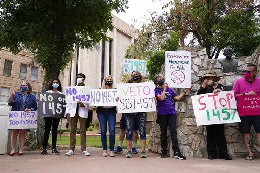 A number of Arizona reproductive health, rights, and justice advocates protest an abortion bill at the Arizona Capitol on Monday, April 26, 2021, in Phoenix. The Arizona Legislature has approved a ban on abortion after 15 weeks. The House approved the measure Thursday, March 24, 2022, a month after the Senate gave its ok, and it now heads to Republican Gov. Doug Ducey for his expected signature. (AP Photo/Ross D. Franklin, File)