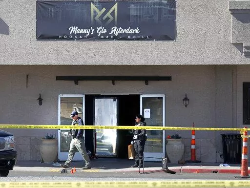 Las Vegas police investigate at Manny's Glow Ultra Lounge & Restaurant, after a shooting, Saturday, Feb. 26, 2022, in Las Vegas. Multiple people were shot before dawn Saturday morning at a hookah parlor. (Chitose Suzuki/Las Vegas Review-Journal via AP)