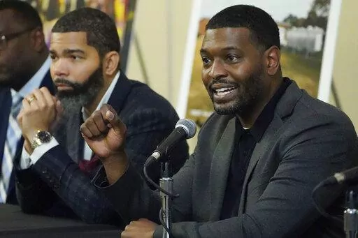 EPA Administrator Michael S. Regan, right, addresses a roundtable of Jackson-area businesspeople, community leaders, residents and educators, about the efforts underway to deliver a sustainable water system for residents as Jackson, Miss., Mayor Chokwe Antar Lumumba, left, listens, Tuesday, Nov. 15, 2022, at Jackson State University, in Jackson, Miss. (AP Photo/Rogelio V. Solis)