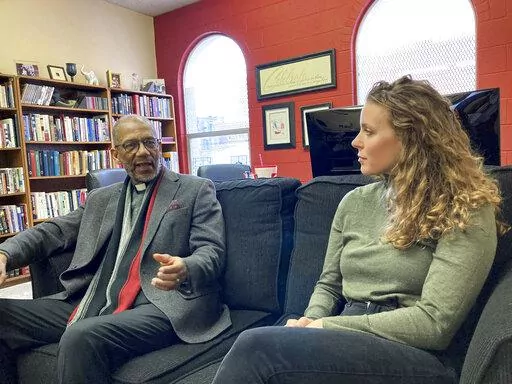 The Rev. Darryl Gray, left, and the Rev. Lauren Bennett speak in Bennett's office in St. Louis, Mo., on Jan. 10, 2023. Both served as spiritual advisers at recent executions in Missouri, sitting alongside the inmates and touching them as the process occurred. Spiritual advisers have been increasingly present during executions since a Supreme Court ruling last year. (AP Photo/Jim Salter