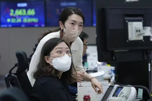 Currency traders watch monitors at the foreign exchange dealing room of the KEB Hana Bank headquarters in Seoul, South Korea, Thursday, June 2, 2022. Asian shares declined Thursday, echoing a retreat on Wall Street as investors fretted about higher interest rates and rising coronavirus cases in parts of the region. (AP Photo/Ahn Young-joon)