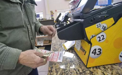 Bruce Gideos, floor manager at Pierre's Place, in Chesterfield, N.H., prints out Powerball tickets on Thursday, Nov. 3, 2022. The Powerball jackpot climbed over $1.5 billion on Thursday after no one won Wednesday's drawing. (Kristopher Radder/The Brattleboro Reformer via AP)