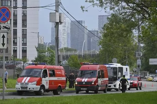 Police and emergency vehicles parked at the side of the wreckage of the drone fell near the Karamyshevskaya embankment to the after a reported drone attack in Moscow, Russia, on Friday, Aug. 11, 2023. The Mayor of Moscow, Sergei Sobyanin said a drone fell in western Moscow after it was shot down by air defense systems. Sobyanin said no-one was hurt when the drone fell near Karamyshevskaya embankment and that no serious damage was caused. Russian social media channels shared videos of what they s