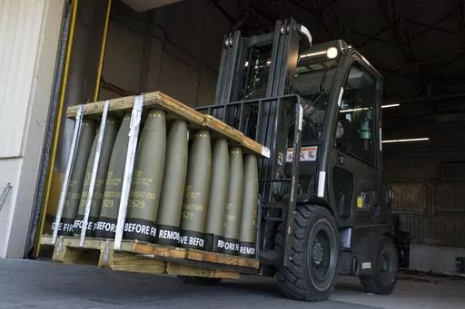 Airmen with the 436th Aerial Port Squadron use a forklift to move 155 mm shells ultimately bound for Ukraine, April 29, 2022, at Dover Air Force Base, Del. Officials say the U.S. will send Ukraine about $500 million in ammunition and equipment and will spend more than $2 billion to buy an array of munitions, radar and other weapons in the future. (AP Photo/Alex Brandon)